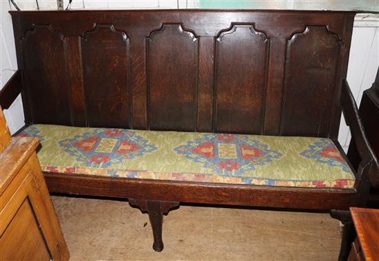 An 18th century carved oak settle, W. 6ft. D. 2ft 3in. H 3ft 4in.